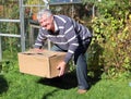 Man lifting heavy box correctly. Royalty Free Stock Photo