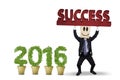 Man lifting a success text with numbers 2016