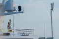 Man lifting weights and exercising on his private yacht, moored in Port Adriano