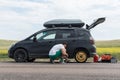 A man lifts a car to replace a tire Royalty Free Stock Photo