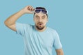 Man lifts his sunglasses and looks at something with funny surprised happy face expression Royalty Free Stock Photo