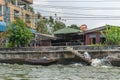 Man lifts small boat out of Bangkok Noi Canal, Bangkok Thailand Royalty Free Stock Photo