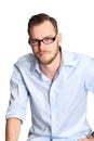 Man in light blue shirt and jeans sitting down Royalty Free Stock Photo