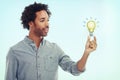 Man, light bulb and business entrepreneur or idea for creative designer for career growth, blue background mockup space Royalty Free Stock Photo