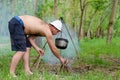 Man lighting a cooking fire while camping