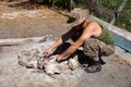 A man lighting a fire on a camping trip