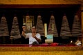 Man lighting incense in chinese temple vietnam