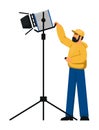 Lighting technician with spotlight equipment on white