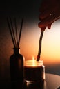 Man lights a candle. the concept of a cozy home relaxing atmosphere. relaxation and aromatherapy Royalty Free Stock Photo