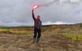 Man lights a signal fire in a field. Trekking in the Klyuchevskoy volcano park