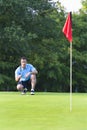 Man Lining Golf Shot - vertical Royalty Free Stock Photo
