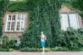 Man listening music building in ivy on background Royalty Free Stock Photo