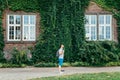 Man listening music building in ivy on background Royalty Free Stock Photo