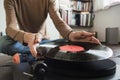 Turntable playing vinyl LP record. Man listening music, relaxing, enjoying life at home. Royalty Free Stock Photo