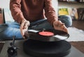 Man listening music, relaxing, enjoying life at home. Turntable playing vinyl LP record. Royalty Free Stock Photo