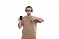 Man Listening to Music from Phone Showing thumb Down. Man Pointing at Phone Green Screen. Isolated