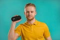 Man listening to music by wireless portable speaker - modern sound system. Young guy dancing, enjoying at blue studio Royalty Free Stock Photo