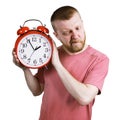 Man listening to the ticking of alarm clock