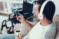 Man Listens to Music in Headphones and Drinks Tea Royalty Free Stock Photo