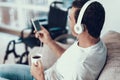 Man Listens to Music in Headphones and Holds Cup Royalty Free Stock Photo