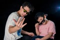 Man and little boy with sunglasses sit looking camera  on dark studio background , asian family Royalty Free Stock Photo