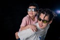 Man and little boy with sunglasses standing looking camera  on dark studio background , asian family Royalty Free Stock Photo