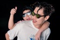 Man and little boy with sunglasses standing looking camera  on dark studio background , asian family Royalty Free Stock Photo