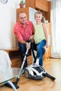 Man and little girl hoovering at home Royalty Free Stock Photo