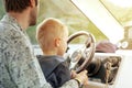 Man with little son driving boat Royalty Free Stock Photo