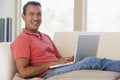 Man in living room using laptop Royalty Free Stock Photo