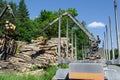 Man load felled trees logs with crane to trailer Royalty Free Stock Photo