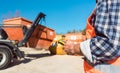 Man loading of construction debris container on truck Royalty Free Stock Photo