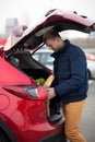 Man loading a shopping bag in car Royalty Free Stock Photo