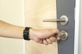Man locking a door knob and stainless steel door handles on a wood door Royalty Free Stock Photo