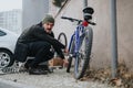 Man locking his bicycle with a chain to prevent theft in the city Royalty Free Stock Photo