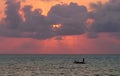 Man on lone boat at sunset off coast of Jambiani, Zanzibar Royalty Free Stock Photo