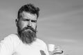 Man with long beard enjoy coffee. Coffee gourmet concept. Bearded man with espresso mug, drinks coffee. Man with beard