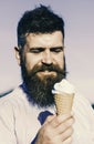 Man with long beard enjoy ice cream. Sweet tooth concept. Bearded man with ice cream cone. Man with beard and mustache Royalty Free Stock Photo