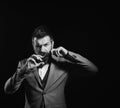 Man with long beard holds scissors. Macho in formal suit Royalty Free Stock Photo