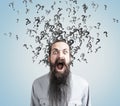 Man with long beard and question marks, gray wall Royalty Free Stock Photo