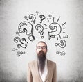 Man with long beard and question marks Royalty Free Stock Photo