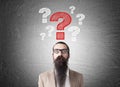 Man with long beard and question marks Royalty Free Stock Photo