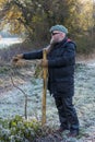 Man with long beard ties crooked small tree stick Royalty Free Stock Photo