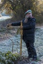 Man with long beard ties crooked small tree stick Royalty Free Stock Photo