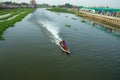 A man with long boat, with a small motor driving a propeller at the end of a long shaft in the canal Royalty Free Stock Photo