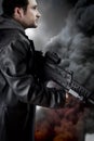 Man with long leather jacket and assault rifle Royalty Free Stock Photo