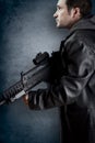 Man with long leather jacket and assault rifle Royalty Free Stock Photo