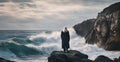 a man with long white hair standing on a rocky beach in front of a crashing Royalty Free Stock Photo