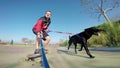 Man on longboard with dog