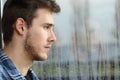 Man longing and looking through window